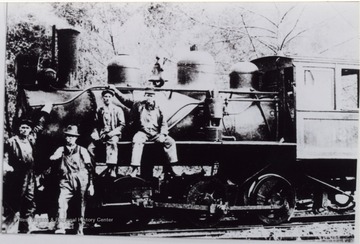Crew is posed in front of the locomotive.