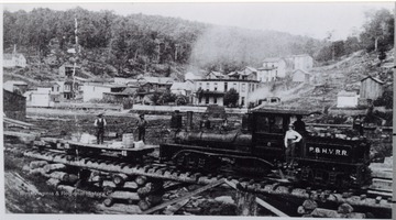 Portrait of men posing with a logging train.