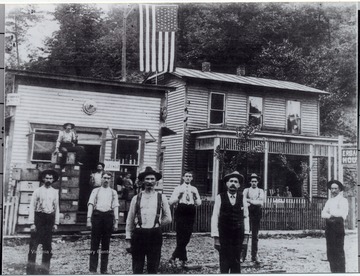 Portrait of men standing outside the Erbacon House and Saloon.