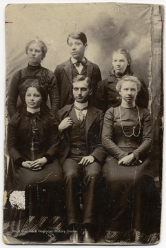 From "Beckley U.S.A." by Harlow Warren, p. 364, vol.2. On back of portrait: "Seated left to right: Bessie Willis (Tucker), A.Z. Amajiah (sp) Lilly (Teacher), Nora Ball (Burton). Standing: Ida Ball (Cooper), George Willis and Stella Lemon (Ford)."