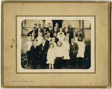 From "Beckley U.S.A." by Harlow Warren, p. 387, vol. 2. In book: "Top row: l. to r.: Frank Brubeck, Forrest Logan, Rexford Thompson, Wendell Smith, Miss Hallie Harper (Teacher). Glenn Sutphin, Helena Daubenspeck (?).Second row: James Bibb, Erskine Dunn, Oppie Hedrick, Howard Meadows, Ray Martin, Beulah Snyder, Monetta Phipps, Bill Ware. Third row: Howard Armstrong, Jck Hatcher, Edith Phipps, Golda Lilly, Dale Tolbert, Edward Ellison, Rosalie Stover. Front row: Clarence Bibb, Phillip Wilkes, Ernest Merrill, Edna Lilly, Mildred Turner, Edith Hollandsworth (in front), Mary Meadows, Gladys Meadows, Tom Ragland, Sara Elizabeth McGinnis" (p. 387). On back of portrait: "In three rows; left to right: first (jagged)."