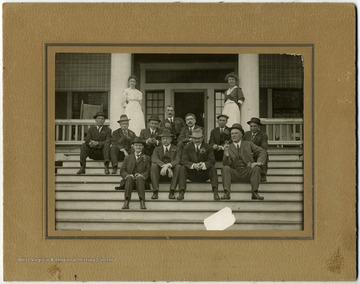 From "Beckley U.S.A." by Harlow Warren, p. 391, vol. 2. In book: "Just exactly what occasion being celebrated here, was not learned. However, those shown are, standing: Mrs. E. E. White and daughter, Miss Julia White. Top row: E. B. Wray (father of Dr. E. B. Wray, chief clerk and still residing in Glen White); Joseph I. Doran, chief counselor for Beaver Coal Co., Beckley and Philadelphia and the Norfolk &amp; Western Railway Co.,; Robert F. Roth chief engineer for E. E. White Coal Company. (Now living in Martinsburg, W. Va.); Thomas H. Wickham, coal operator, Realtor and former superintendent of the Beaver Coal Company at Beckley; unidentified but reportedly, one of the directors named on the opposite page; Sam Adsit, traffic manager Deepwater (now Virginia) Railway Co., and L. R. Taylor, superintendent of the Deepwater Railway, Princeton Division, and coal operator in his own right.The significance of the azalea boutonnieres, for only the gentleman, and why Mr. White (see left hand) did not design to don his, were also not learned. Lower row: two other unidentified, but happy, directors; William MacTaggart and E. E. White. This home, with its seven or more acres of rolling hillside, is now owned and occupied by Mr. and Mrs. Robert B. Parker. The number of rooms it contains is almost uncountable" (p. 391).