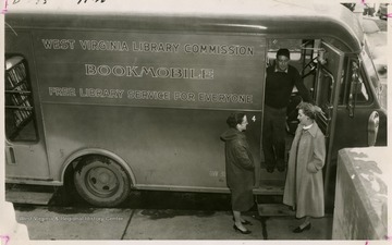 From "Beckley U.S.A." by Harlow Warren, p. 735, vol. 2. In book: "West Virginia Library Commission 'spreads the good word' broadside; Mrs. Felix Fisher, bookmobile librarian, confers with the driver Fred Pennington and County Librarian Mrs. C. H. Graham" (p. 735).