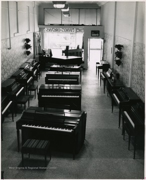 From "Beckley U.S.A." by Harlow Warren, p. 699, vol. 2. In book: "Jan Campbell Piano Co., Inc. Beckley, W. Va. and Bluefield, W. Va." (p. 699). In the portrait, a dozen pianos are displayed on the store floor.
