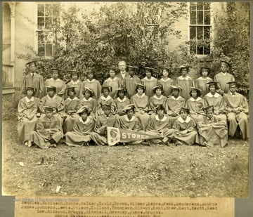 Class of 1924 in caps and gowns at Storer College with college Pres. McDonald. First Row: Reddick, Robinson, Boone, Walker, Gould, Brown, Wilmer, Keyes, Peek, Henderson, Bourne. Second Row: Jones, Johnson, Lewis, Wilson, Holland, Thomson, Gibson, Kent, Drew, Kent, Scott, Reed. Third Row: Law, Rideout, Branch, Mitcehell, Sweeney, Jones, Brooks. Absent from photo: Marie Graham and Sarah Fox.