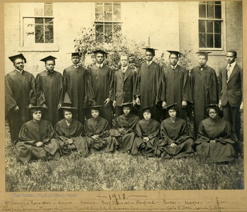 Group photo of Storer College graduates, class of 1918, in caps and gowns in front of building. First Row: McDaniel, Robertson, Case, Howell, Prof. Daniel, Warfield, Parker, Jackson, Neal. Second Row: Odetta Johnson, Margaret James, Myra McKirk, Vida McHipewell, Beatrice Calloway, Katie McDavis, Lucinda E. Ross.