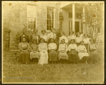 Mrs. McKinney's Class in front of building. All women except one male, first left on back row.