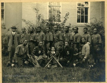 Group photo of Storer College baseball team in uniform. First Row: Myers (Mgr), Lewis (2ndB), Tomlinson, Fisher (Lf), Morris (3rdB), Harvey (1stB), Diggs (C), Scott (SS), Arte (CF), Hill (RF). Second Row: Tindley, Harris, Delaney, (mascot with bats), Reese, King.