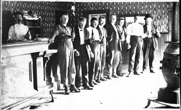 Right to left: Andrew Hedricks, Tom Workenbaker, Truman Nethkin, Lafe Troy, Smith Dugger, unidentified, Dr. Harper Judy (wearing bow tie), unidentified woodsman and bartender.