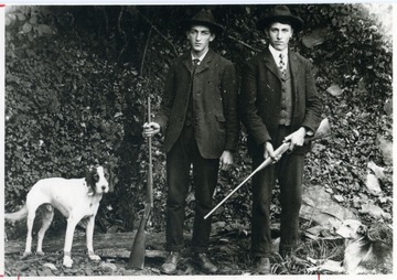 Edward and Emil Metzener with their hunting dogs.