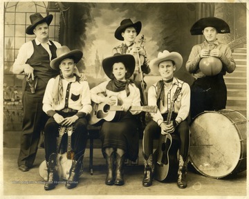 Seated left to right: Curley Slim; "Sunflower" Mary Calves; Doc Williams; Standing left to right "Cap"; Cy Williams; "Rawhide" Hamilton Fincher. Performed at WWVA Wheeling or WMMN Fairmont.
