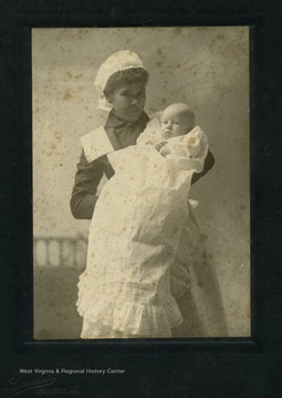 Unidentified African-American nurse holding three month old infant,
