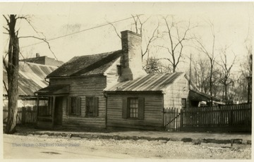 An old wooden house with chimney.