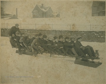 Unidentified students spoon together on a unique sled complete with "headlights".