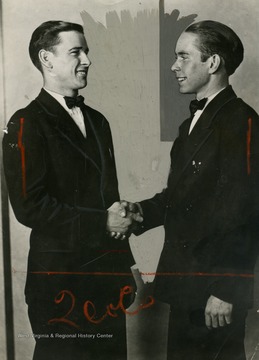 Bob McCoy on the left, shaking hands with Joe Hatfield, as the "Last Survivors of the Celebrated Feud" between the Hatfield and McCoy families.