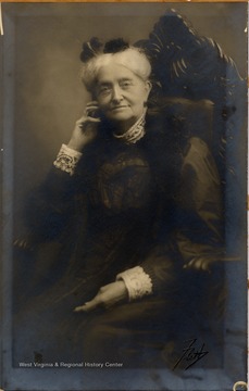 Older woman dressed in eloquent, early 20th century attire