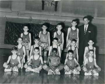 Team portrait of a little league basketball team coached by George DeAntonis