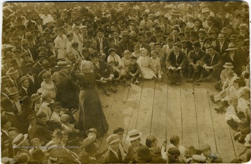 Photograph postcard of labor organizer Mother Jones on August 4th speaking at the Montgomery ballpark to a well dressed group of people including, blacks, whites, adults and children.