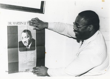 Edward Cabbell displaying a poster of Dr. Martin Luther King.