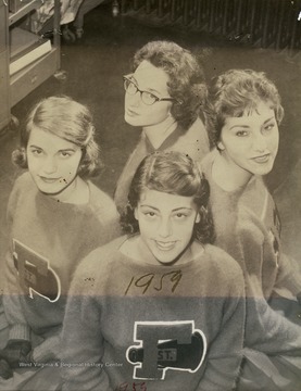 Group portrait of unidentified members of the St. Francis High School Cheerleaders in uniform.