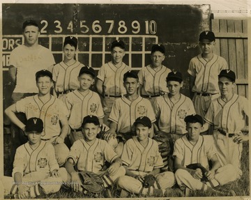 Group portrait of Pony League team. Only identified members are Coach Whitey De Moss, standing back row, first on the left and Sprioff, second row, first left.