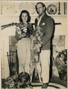 Co-Authors, George Bird and Kay Evans pose with others members of their family, "Blue and "Ruff" while Kay holds a copy of the couples' first novel, "Death In Four Colors", published under the pen name, "Brandon Bird". The photograph was taken at their home, "Old Hemlock Farm" in Preston County, West Virginia. 