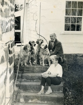 George and Kay Evans pose on the steps of their home with four blue belton setters.