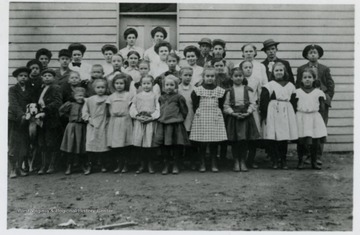 First Row left to right: Mary Cordray Thorn, Blanche Ramsey, Virginia Sanders Yost, Lana Hoffman, Gladys Barnhart, Cecil Kennedy, Blanche Cole Fife, Jessie Core Donley, Rose Core Parker Cole, Mamie Cole Mehlinger, Lenna Core Dent. In doorway Winnie Cordray Neely, June Houston: Teacher. Second row left to right: Jessie Fox, William Core (Fred), Lorentz Berry, Ralph Berry, Wyland Tucker, Cora Henderson Simpson, Emma Henderson Cordray, Enid McElroy, Nora Kennedy, Cecil Riley Everly, Nannie Cordray Lynch. Third Row left to right: Grace Famsey, Eldon Tucker, Edna Barnhart, Alta Riley Sutton, Abbie Sanders Hoffman, Cecil Riley, Earl Core, Izora Hoffman, Mildred Barnhart, Ed Riley, Barton Core.