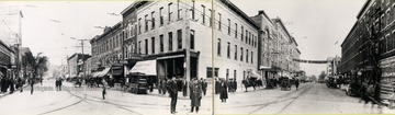 A Republican Headquarters banner hangs across a street as a police officer stands in an intersection. The traffic includes Model-T automobiles, motor trucks, horse drawn buggies and wagons.
