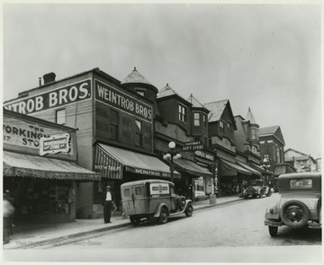 Pleasant Street lined with businesses, such as Weintrob Brothers, Glassman's and Peoples Market.