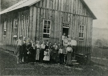 The group of unidentified people are probably members of the congregation. The church is located in the Clay District of Monongalia County.