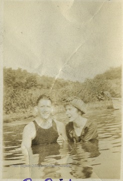 Swimming in their early 20th century bathing suits.