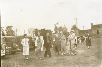 Several adults pose in parking during a Summer School visit at Arthurdale, West Virginia.