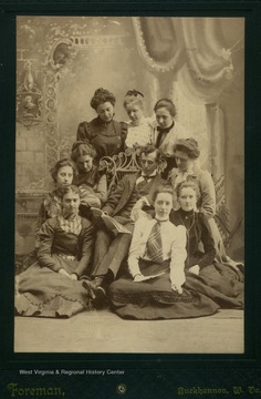 Unidentified female students pose around A. Lee Post.