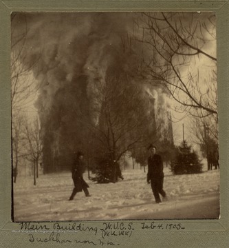 People hurry by as the Seminary's main building is destroyed by fire.