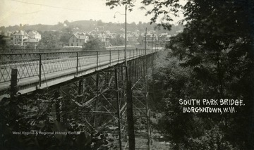 Postcard photograph of the South Park Bridge, also known as the Pleasant Street Bridge. Deckers Creek flows under the bridge. See the original for the correspondence written on the back.