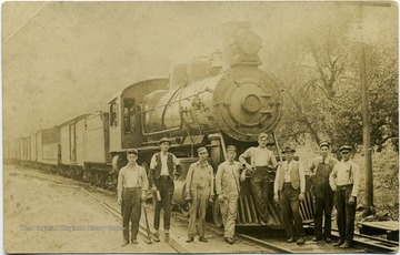 Postcard photograph of probably a Kanawha and Michigan Railroad train and workers with Engine No. 518. Identified are Brakeman Arthur Ratliff, 2nd from the left and Engineer Fred B. Secrest, 4th from the left. 