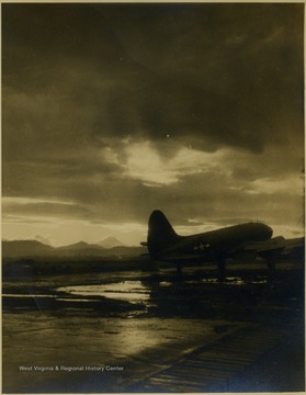 A C-46 Transport Aircraft sits on a runway somewhere in the Pacific during World War II.