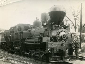 Man holding the child is probably James Williams. This was possibly the last steam powered locomotive to pass through Hinton. Other information on the back on the photograph includes: "Hinton Daily News Coll. from Fred Long to Stephen Trail Su Co WV ... - 1996"