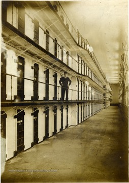 Unidentified guard stands on the second level of cells inside the state prison.