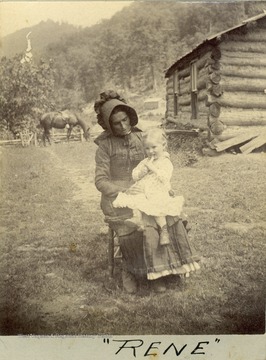 An unidentified woman, wearing a matching sun-bonnet and dress, holding a little girl on her lap.