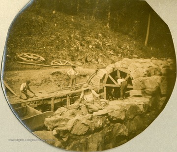 Unidentified workers use molds to form the arch in a culvert during the construction of the Ohio extension.