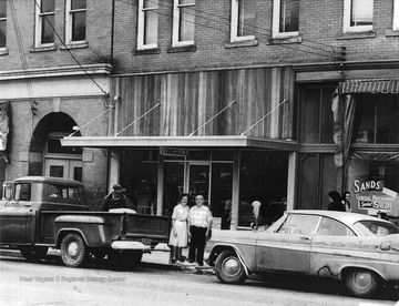 Mr. and Mrs. H. J. Tunstall pose in front of their store, Tunstall's located on Elk Street in Gassaway.