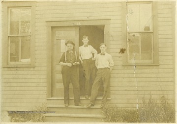 Three young men standing in a doorway. The name of the printer is unknown. 