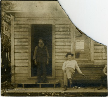 The shop's street number over the door is 359. The two men in the photo are not identified. 