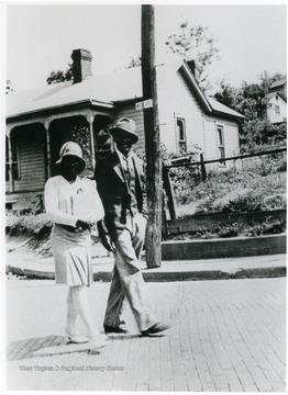 The Edwards strolling along White Avenue. Information on p. 146 in "Our Monongalia" by Connie Park Rice. Information with the photograph includes "Courtesy of Bobbie Drew Ward".