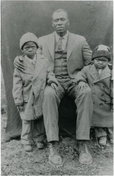 Norris Finney poses with two small boys, unidentified, but are most likely his sons. Information on p. 150 in "Our Monongalia" by Connie Park Rice. Information with the photograph includes "Courtesy of Kitty Hughes".