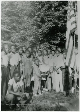 Camp Muffly was a 4-H site in Monogalia County. Segregated black and white members attended Camp Muffly in Clinton District at different times. All persons in the photo are not identified.Information on p. 138,139,140 in "Our Monongalia" by Connie Park Rice. Information with the photograph includes "Courtesy of Ivry Moore Williams."   