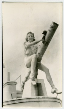 Inscribed on the back of the photo, "Jeannette Richards, last years sweetheart cleans the battleship for the 1939 maneuvers."