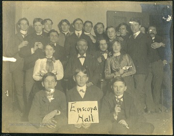 Several wide-eyed subjects in this photograph are holding pistols.